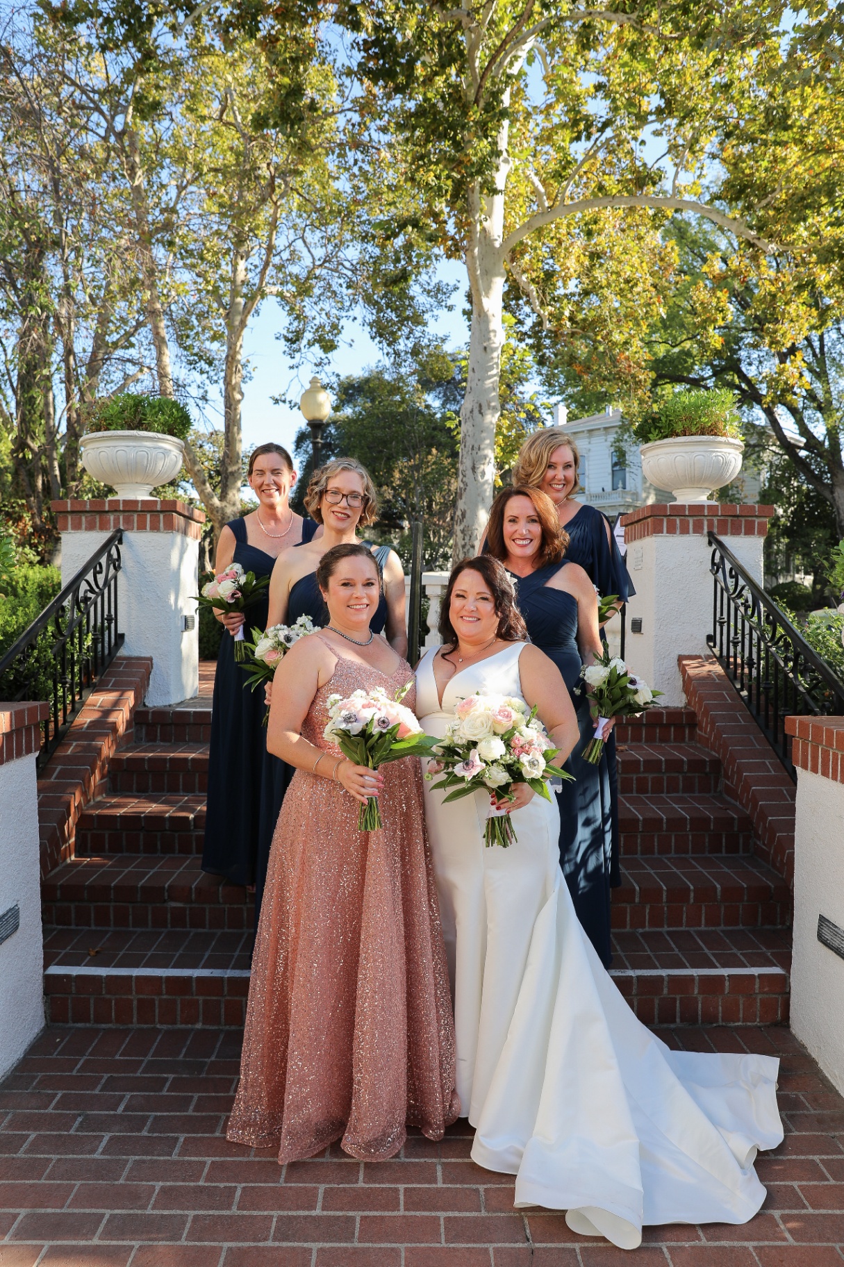 Bride and bridesmaids on garden steps — Yours & Mine Photography